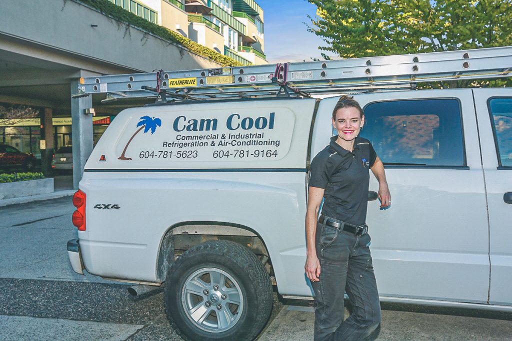 Jessica is in front of her work truck.