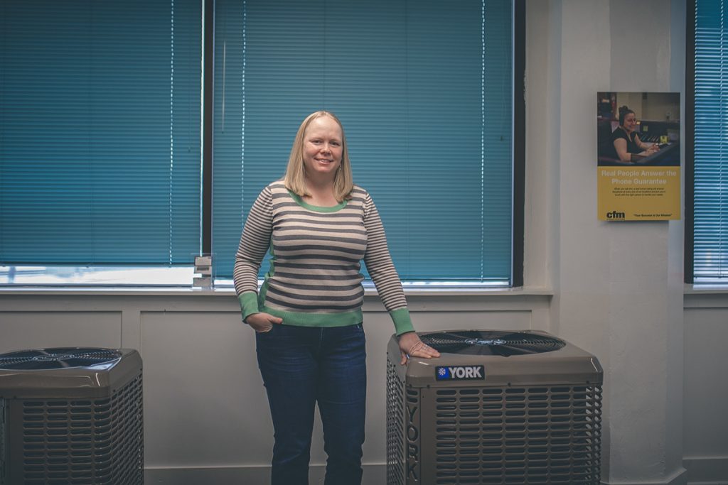 Picture of Lauren, she is standing between two York HVAC units.